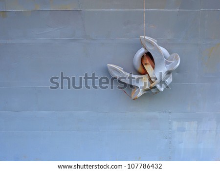 Old anchor on gray background