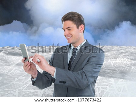 Businessman on phone in sea of documents under sky clouds