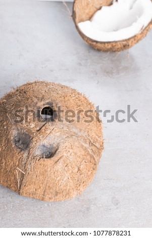 raw organic broken coconut on grey table