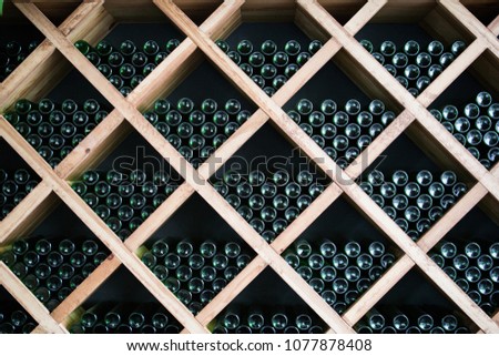 Bottles of wine in a wine cellar. Royalty-Free Stock Photo #1077878408