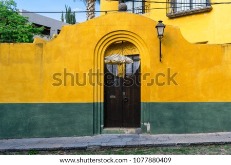 Brightly painted yellow green house front