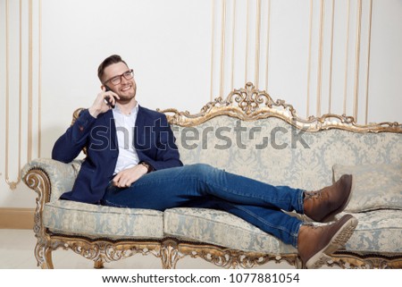 guy with a phone on the couch