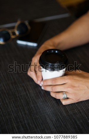 women's hands and a glass of coffee, the concept of coffee with you