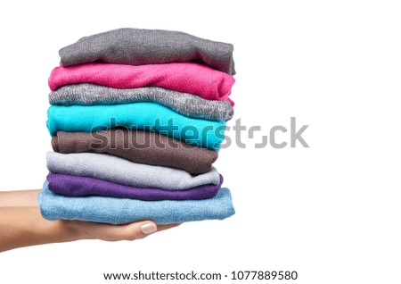 pile of multi color fabric texture with hand, wool cloth isolated on white background.