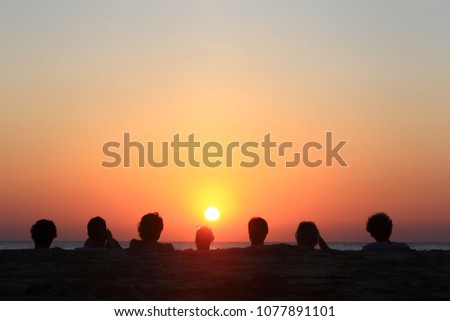 Silhouette of friends enjoying sunset