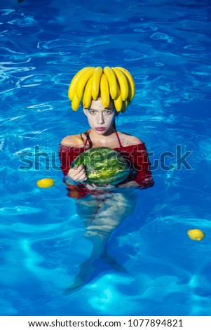girl hold watermelon in swimming pool resort hotel - tasting tropical fresh fruits - Summer vacation concept
