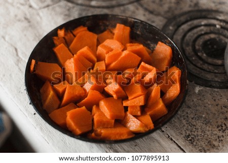 pumpkin, which is fried in a frying pan