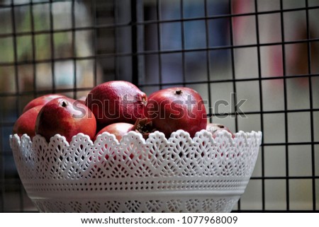 Stock photos, pictures and royalty-free images of Full basket with just picked fresh red ripe organic pomegranate fruit on the table natural background.