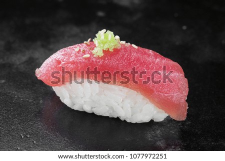 Sushi nigiri with tuna on black background
