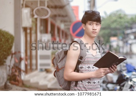 Tourist man try navigate himself with map and smartphone in unknown city