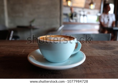 cup of coffee on table in cafe - vintage style effect picture