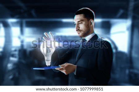 business, augmented reality and future technology concept - businessman in suit working with transparent tablet pc computer and hologram over abstract background