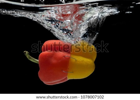 Abstract yellow-red pepper, splash of water.
