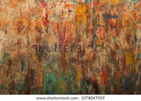 The wall is stained red,orange,green,blue background/texture