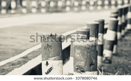 Black and white concrete pillars of a vacant road isolated unique stock photograph