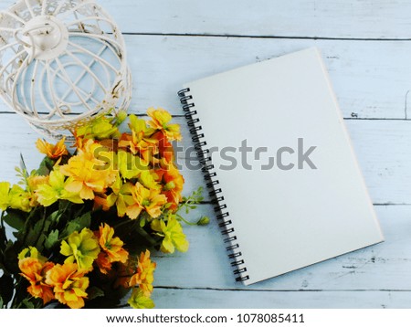 flowers bouquet and blank notebook with copy space background