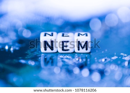 Word NEM formed by alphabet blocks on mother cryptocurrency