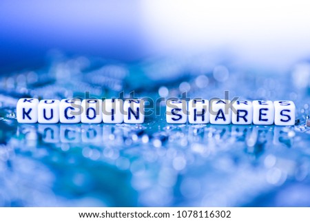 Word KUCOIN SHARES formed by alphabet blocks on mother cryptocurrency