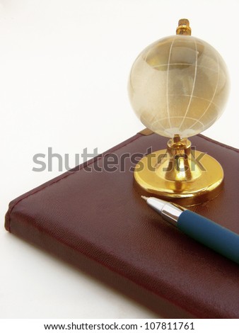 A image showing telephone diary with globe giving a concept of global communication.