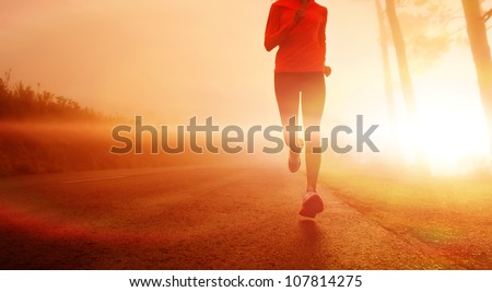 Athlete running on the road in morning sunrise training for marathon and fitness. Healthy active lifestyle latino woman exercising outdoors. Royalty-Free Stock Photo #107814275