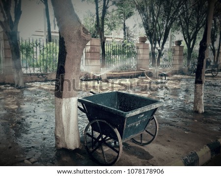 A abandoned trolley / cart on a wet surface on a hot summer day