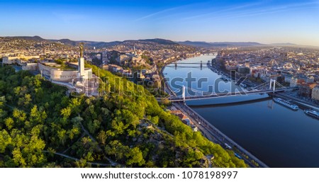 Budapest, Hungary - Aerial panoramic skyline view of Budapest at sunrise. This view includes the Statue of Liberty, Elisabeth Bridge, Buda Castle Royal Palace and Szechenyi Chain Bridge with blue sky Royalty-Free Stock Photo #1078198997