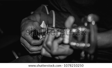 people playing acoustic guitar. selective focus with narrow depth of field