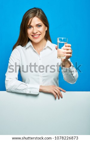 Woman holding water glass. Smiling businesswoman with sign banner below.