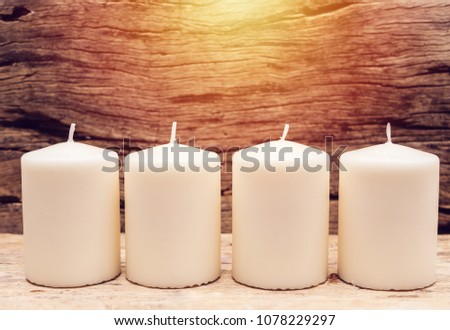 group of white candle with wooden background