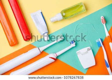 Photo of toothbrushes tubes of pastes, floss