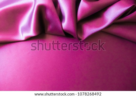 Smooth elegant wavy hot magenta pink satin silk luxury cloth fabric texture, abstract background design.