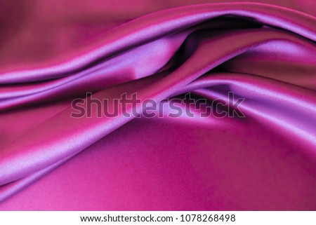 Smooth elegant wavy hot magenta pink satin silk luxury cloth fabric texture, abstract background design.