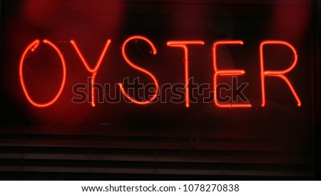 Neon Oyster Sign in restaurant window