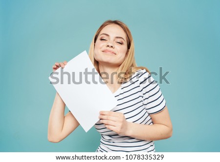 woman holds in her hand a white sheet of paper, vertical arrangement                         
