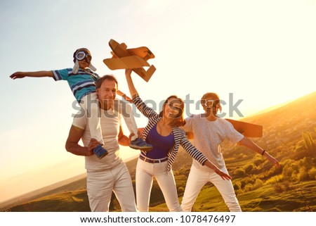 Happy family with nature in the evening at sunset