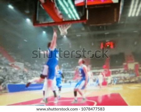 Blurred background. Basketball court. Active team sport with the ball. Athletes play the game