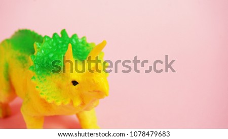 dinosaurs toy on pink background