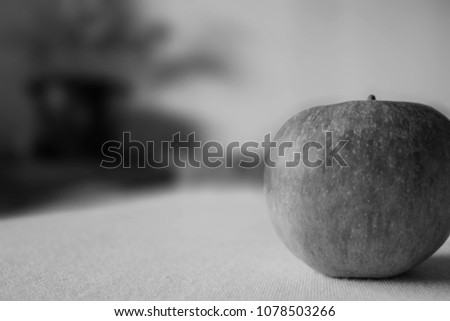 Close up of a red apple with blured background in black and white.