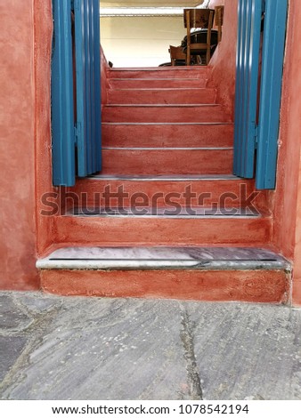 Orange cement ladders and blue wooden door 