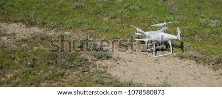White drone with digital camera flying in sky over mountain Drone with high resolution digital camera.