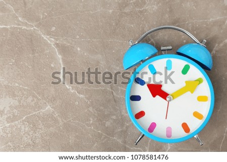 Blue alarm clock on table. Time change concept