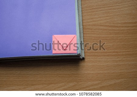 Notepad with small envelopes on the table girl holding hand, education, school