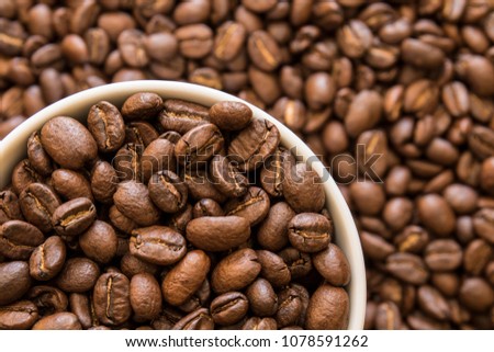 Large cup of tasty roasted coffee beans to be used as a background or wallpaper