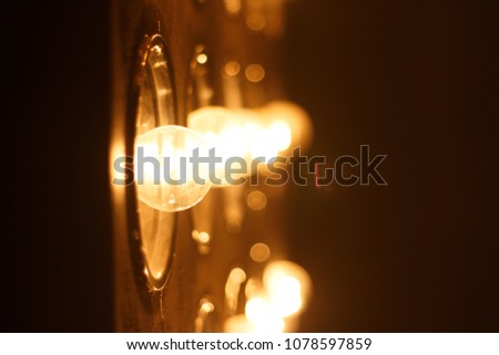 Light bulbs background over dark wall, blur