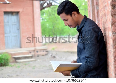 Closeup portrait young business man reading book in The Park