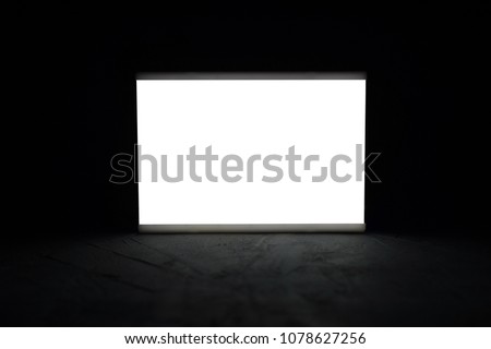 Mock up lightbox luminous display in the dark. Place for text or your design.