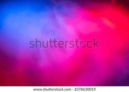 Abstraction of colored smoke close-up on a black background