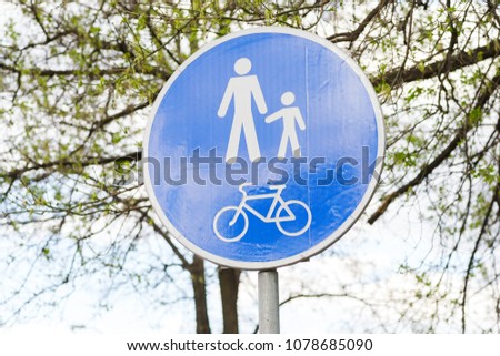 road sign on a blue background for pedestrians and cyclists