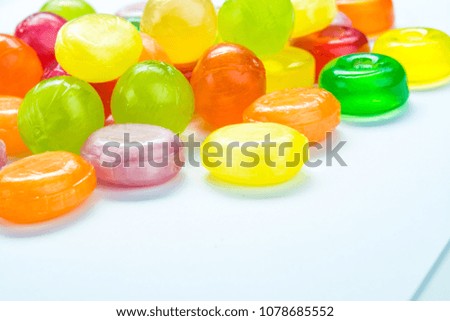 Beautiful colorful and delicious candy sweets and jelly marshmallows. different shapes and composition lollipops and marmalade isolated on abstract blurred white background. Detailed closeup shoot.