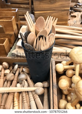 Kitchen utensils made of wood, wooden spoon and fork in the glass